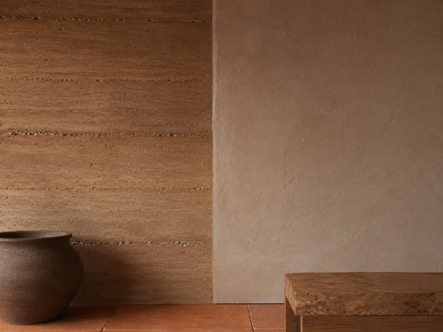 Terra Forma — Material directive: Rammed clay, unglazed terracotta, lime plaster. Nothing sealed to a shine.